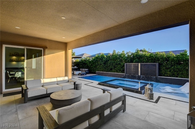 view of pool with a patio, outdoor lounge area, and an in ground hot tub