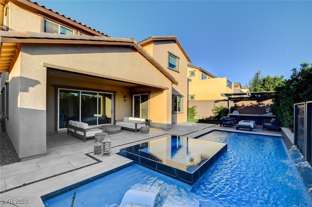 view of pool featuring an outdoor living space, a patio area, and pool water feature