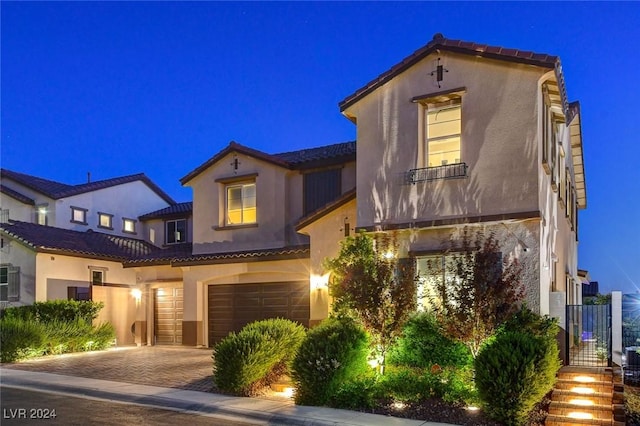 2567 Speyburn Ave, Henderson, NV 89044 - mediterranean / spanish-style house featuring stucco siding, a garage, a tile roof, and driveway