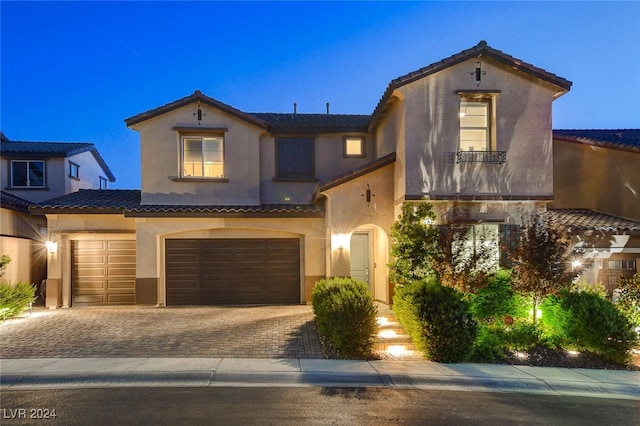 mediterranean / spanish home with a garage