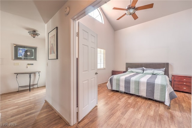 bedroom featuring ceiling fan, light wood-type flooring, and vaulted ceiling