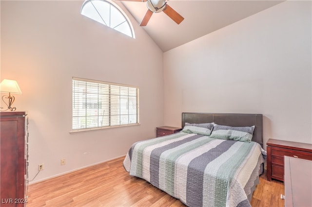 bedroom featuring high vaulted ceiling, light hardwood / wood-style floors, and ceiling fan