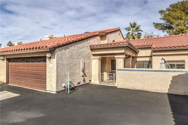 mediterranean / spanish-style home featuring a garage