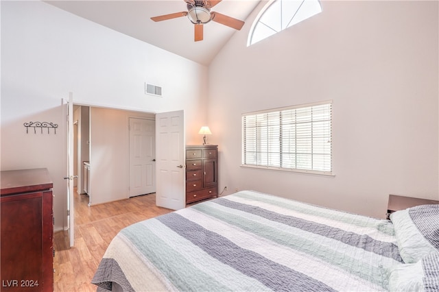 bedroom with light hardwood / wood-style flooring, multiple windows, high vaulted ceiling, and ceiling fan