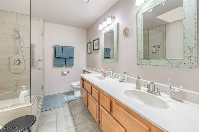 bathroom with vanity, tile patterned floors, toilet, and walk in shower