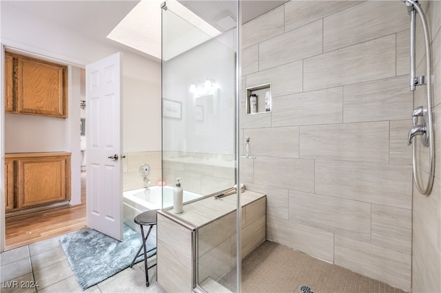 bathroom with hardwood / wood-style flooring and plus walk in shower