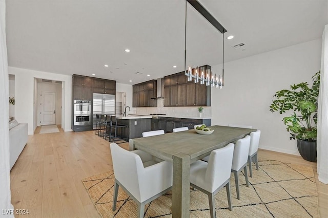 dining area featuring light hardwood / wood-style flooring and sink