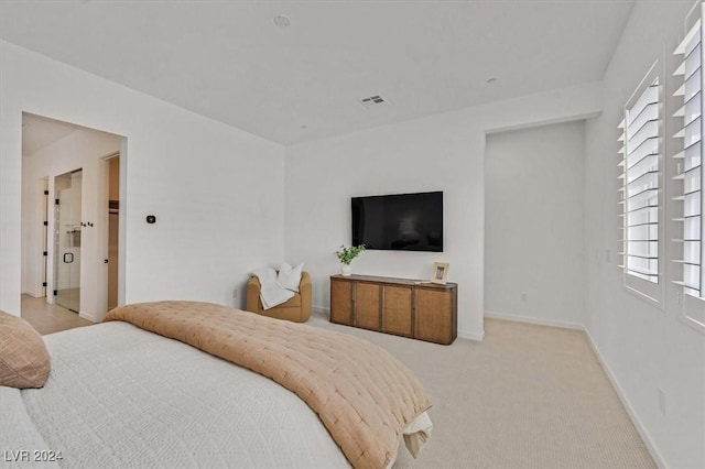 bedroom featuring multiple windows and light carpet