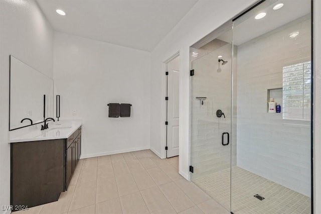 bathroom with tile patterned flooring, vanity, and a shower with shower door