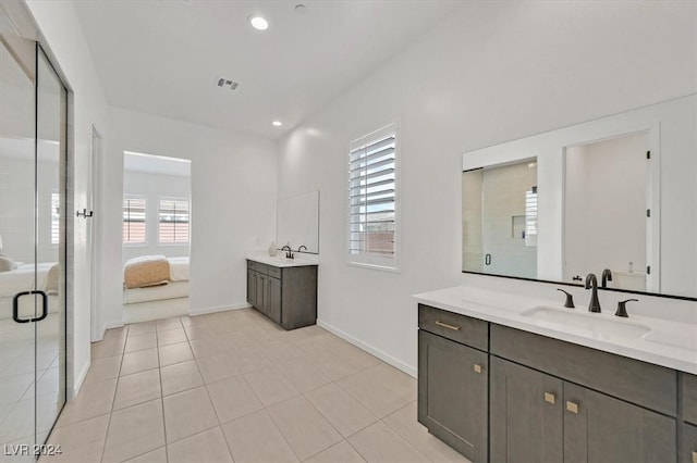 bathroom with tile patterned flooring, vanity, and a shower with shower door