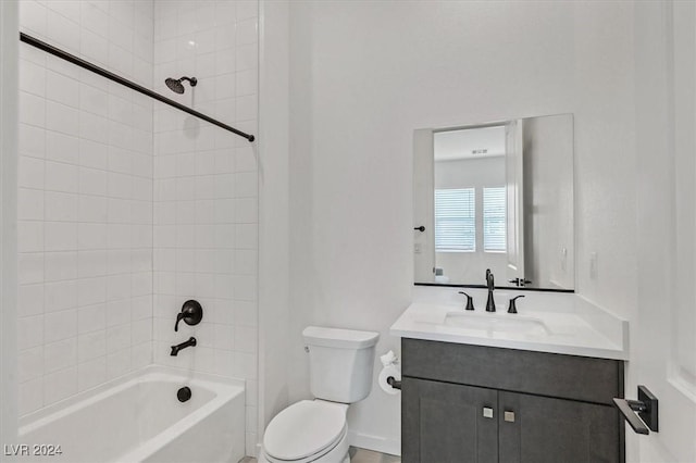 full bathroom with vanity, toilet, and tiled shower / bath