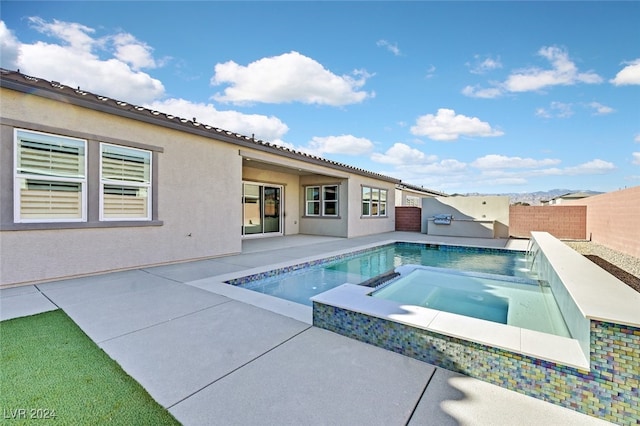 view of swimming pool featuring pool water feature, an in ground hot tub, and a patio