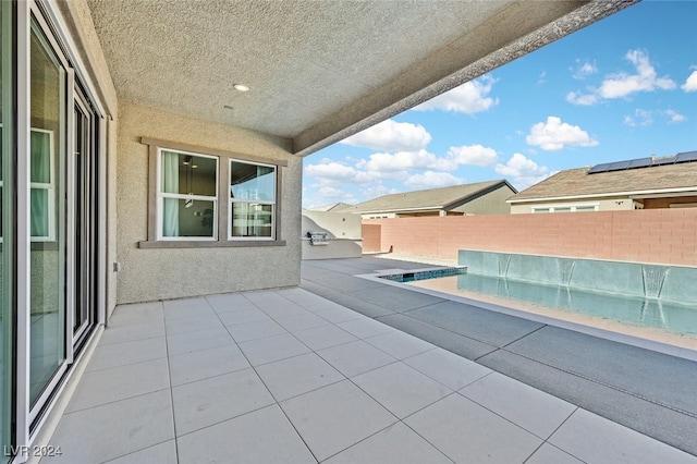 view of pool with pool water feature and a patio