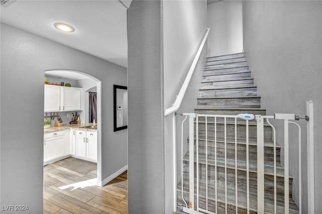 stairway featuring hardwood / wood-style flooring