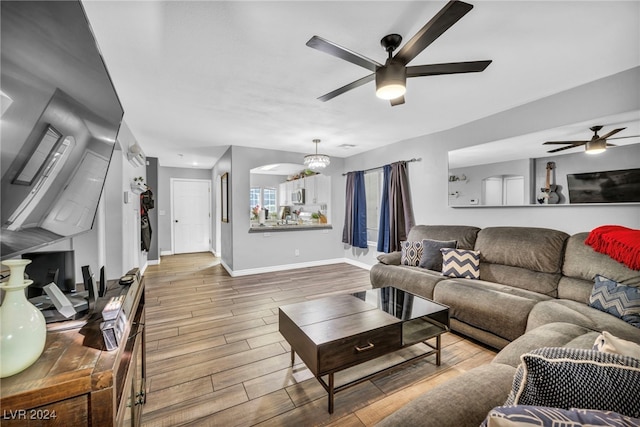 living room with wood-type flooring and ceiling fan