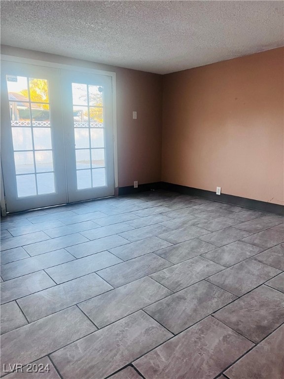 unfurnished room featuring a textured ceiling