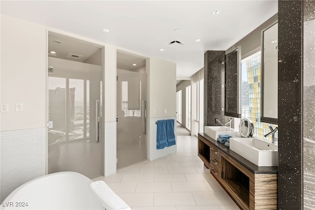 bathroom featuring vanity, a bathing tub, and tile walls