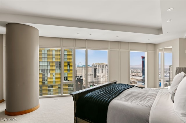 carpeted bedroom featuring access to outside and multiple windows