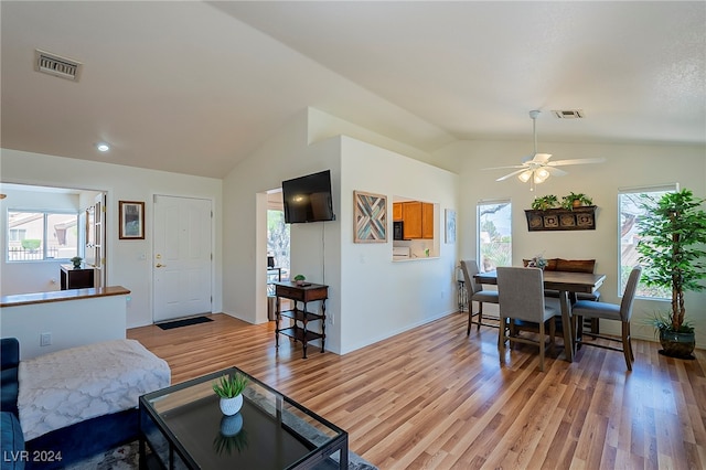 living room with lofted ceiling, light wood-type flooring, and ceiling fan