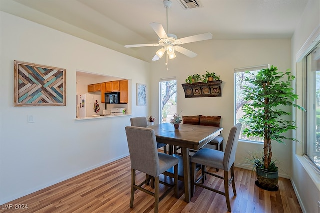 dining area featuring vaulted ceiling, light hardwood / wood-style flooring, and ceiling fan