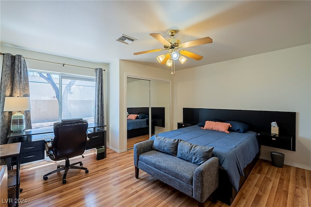 bedroom with light hardwood / wood-style floors, a closet, and ceiling fan