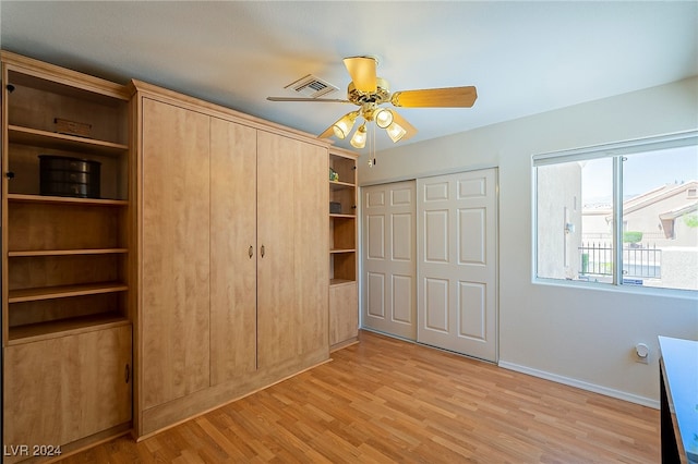 unfurnished bedroom with a closet, ceiling fan, and light wood-type flooring