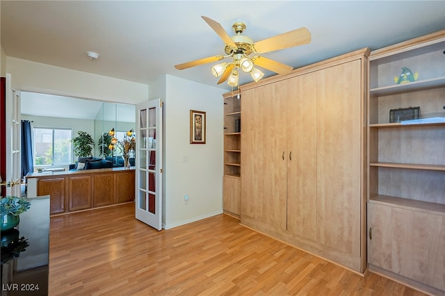 bedroom with light hardwood / wood-style flooring, a closet, and ceiling fan