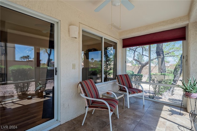 sunroom featuring ceiling fan