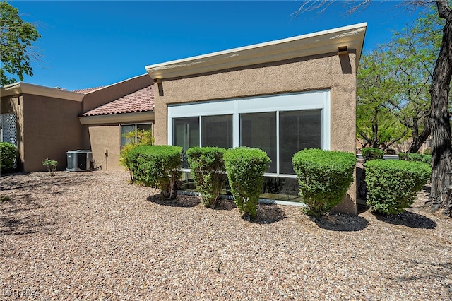 back of house featuring cooling unit