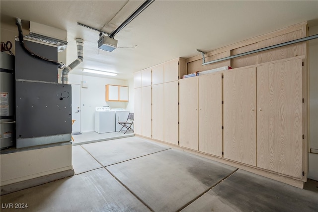 garage with a garage door opener, washer and clothes dryer, and heating unit