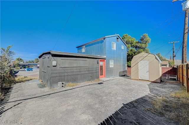 view of side of home with a storage unit