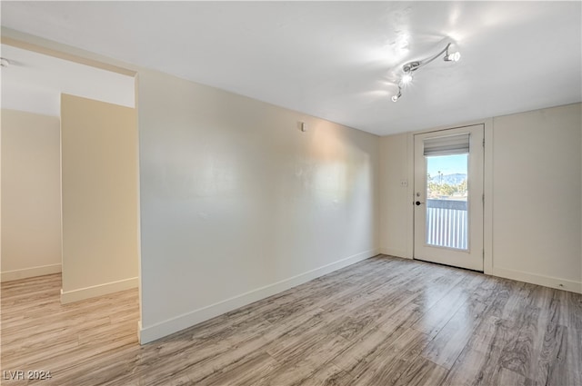 spare room featuring light hardwood / wood-style floors