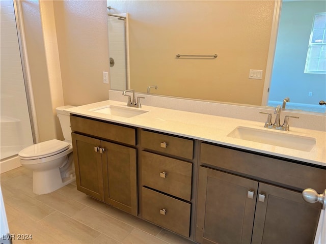 bathroom featuring vanity, an enclosed shower, and toilet