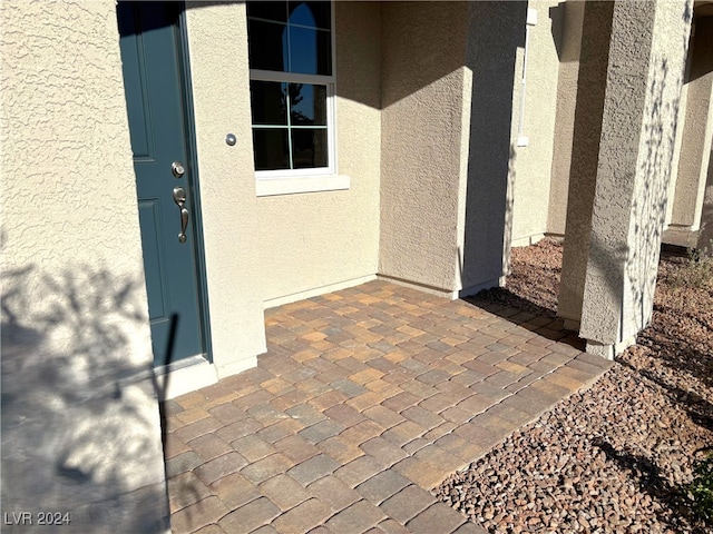 entrance to property featuring a patio area