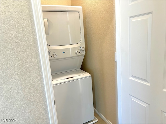 laundry area with stacked washer / drying machine