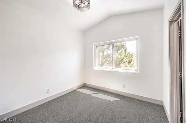 unfurnished bedroom featuring carpet and vaulted ceiling