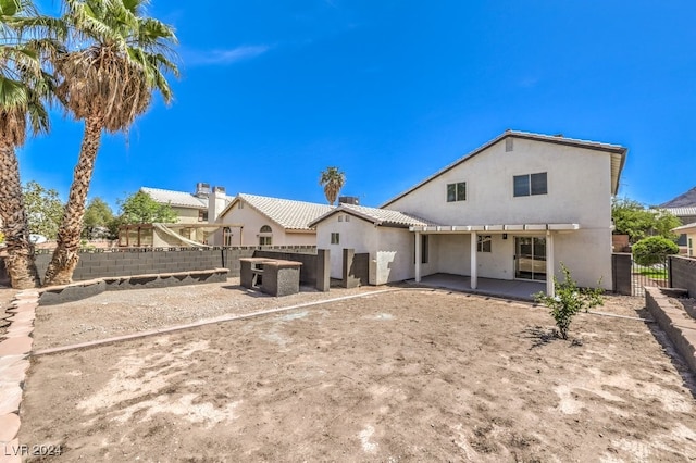 back of property with a patio