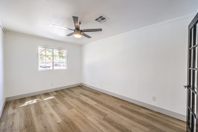 unfurnished room featuring ornamental molding, a textured ceiling, light wood-type flooring, and ceiling fan