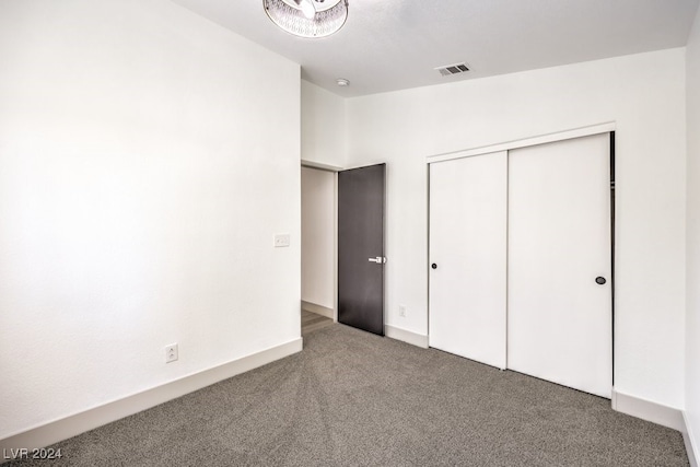 unfurnished bedroom with a closet and carpet