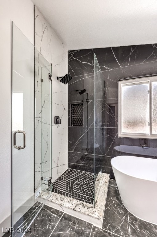 bathroom with separate shower and tub