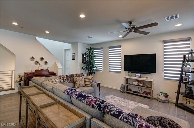 living room with wood-type flooring and ceiling fan