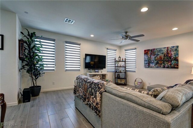 living room with hardwood / wood-style flooring and ceiling fan