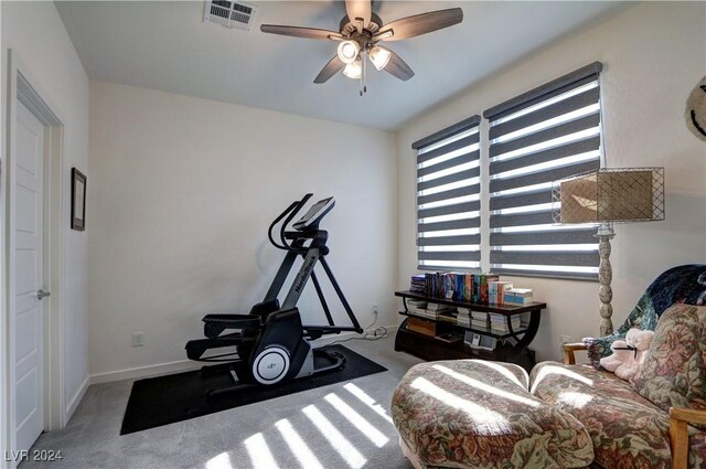 exercise area with ceiling fan and carpet