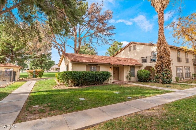 mediterranean / spanish-style house with a front yard