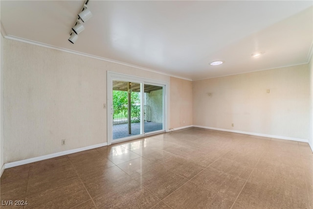 empty room featuring crown molding