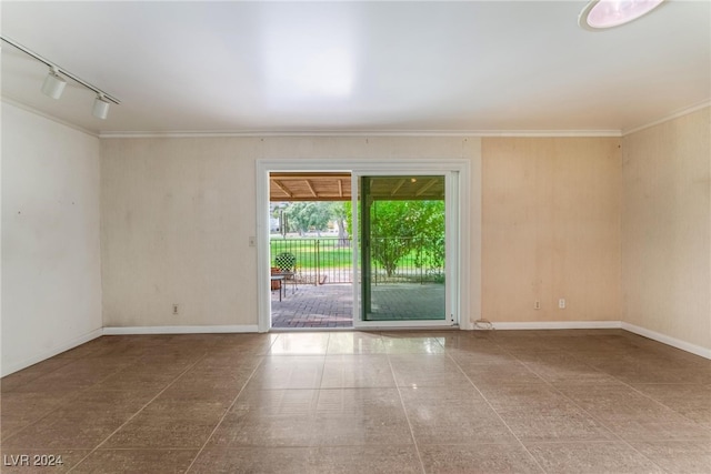 empty room with crown molding and rail lighting