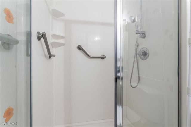 bathroom featuring a shower with door