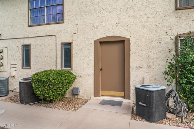 property entrance featuring central AC unit