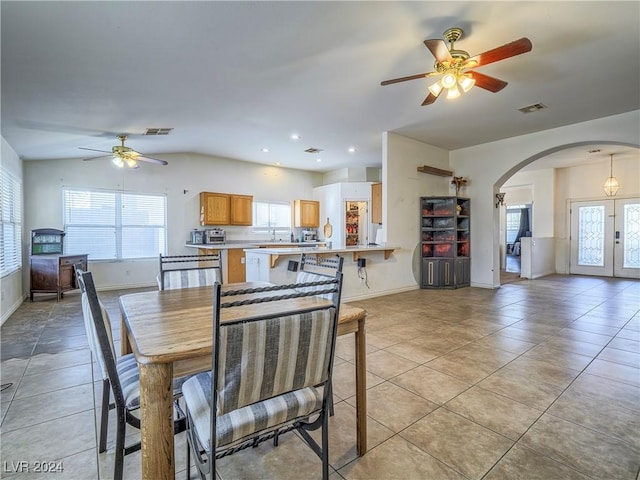 dining space featuring sink, light tile patterned floors, ceiling fan, and french doors