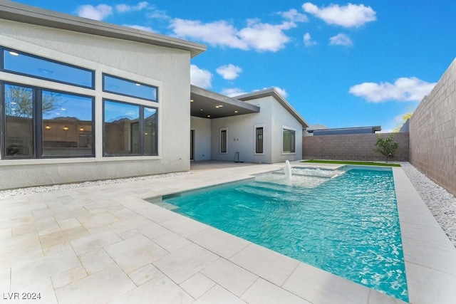 view of swimming pool with a patio and pool water feature